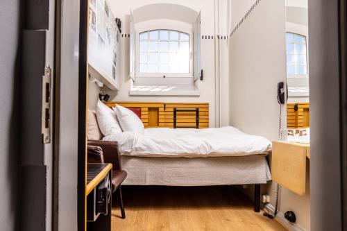 a small room with two beds and a window at Långholmen Hotell in Stockholm