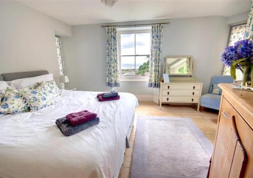 a bedroom with a bed with two pillows on it at Ferndale House Lynmouth in Lynmouth