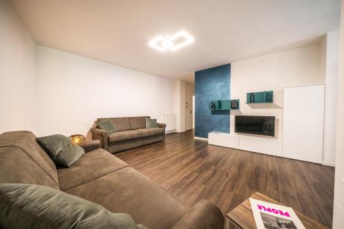 a living room with a couch and a fireplace at Appartamenti Vasco Renna Surf Center in Nago-Torbole