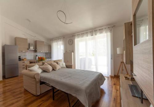 a bedroom with a large bed and a kitchen at Alloggio Turistico Flavia in Anzio