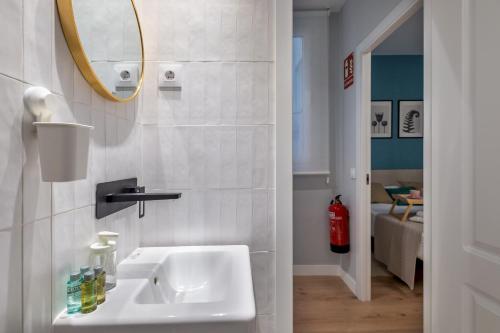 a white bathroom with a sink and a mirror at 2 bedrooms 2 bathrooms furnished - Las Letras - Modern - MintyStay in Madrid