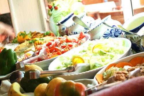 a table with many plates of food on it at Tskaltubo Plaza Hotel in Tskaltubo