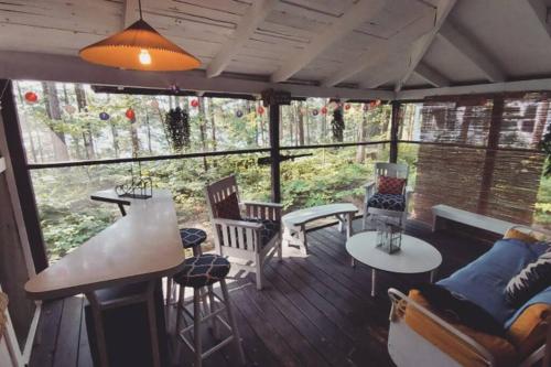 a screened in porch with a table and chairs at Grant Island Waterfront Cottage Brantingham Lk - Dogs Love - Worlds Raddest Island in Glenfield