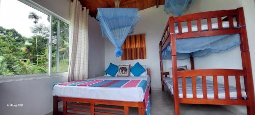a bedroom with two bunk beds and a window at ATT's eagles nest in Kandy