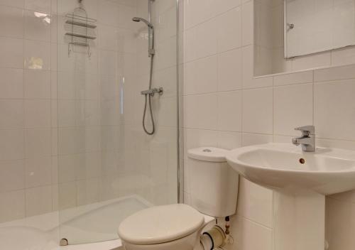 a bathroom with a shower and a toilet and a sink at Harbour Heights Ilfracombe in Ilfracombe