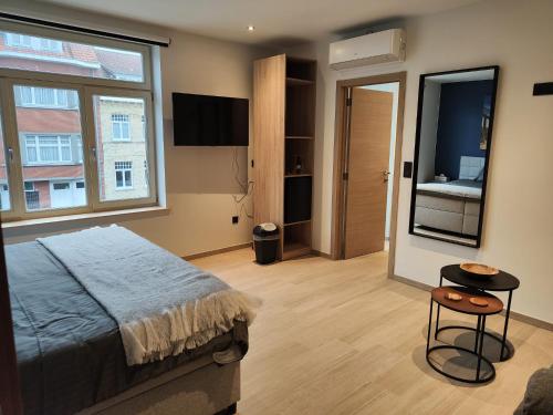 a bedroom with a bed and a large window at Veroli in Bruges