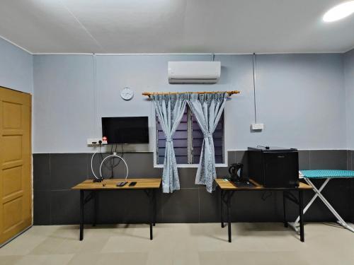 a room with a desk and a tv and a window at TBE Room2stay at Jalan BR3 in Melaka