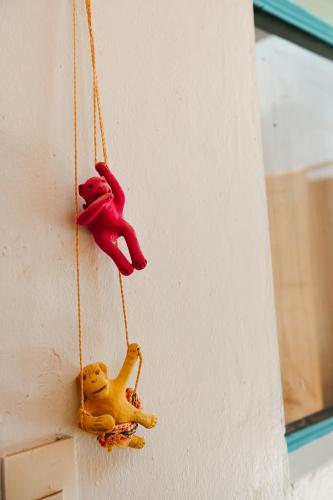 two small toy animals hanging on a wall at Maka Hostel in Oaxaca City