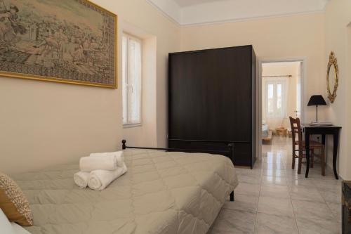 a bedroom with a large bed and a desk at Theros Home Andros in Andros