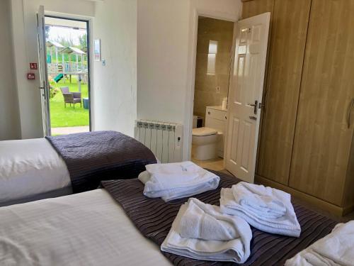 a bedroom with two beds with towels on the floor at The Old Quay House in Hayle