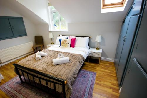 a bedroom with a large bed with towels on it at Atlantic Way Cottage in Galway