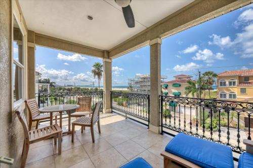 a balcony with a table and chairs and a view of the ocean at Ocean Vue By Beachside Management in Siesta Key