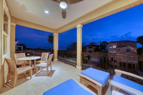 a balcony with a table and chairs and a view of the ocean at Ocean Vue; By Beachside Management in Siesta Key