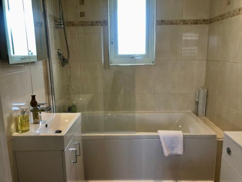 a bathroom with a bath tub and a sink at The Old Quay House in Hayle