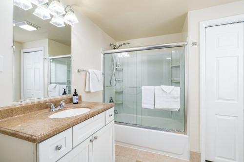 La salle de bains est pourvue d'un lavabo et d'une douche. dans l'établissement Modern Chalet Cabin w Hot Tub, Fire Pit, Huge Deck, à Inwood