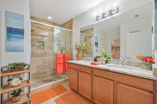 a bathroom with a double sink and a shower at VILLA AWESOME! in Cape Coral