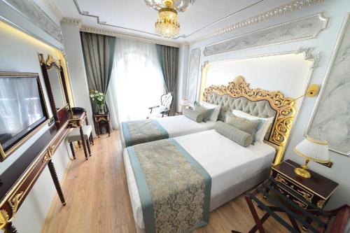 a bedroom with a large bed and a television at Golden Marmara Hotel in Istanbul