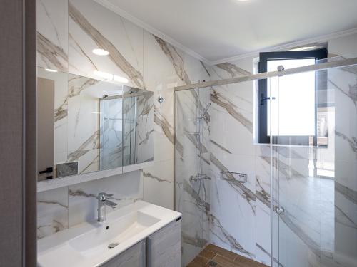 a bathroom with a sink and a shower at Mossa City Apartments in Chania Town
