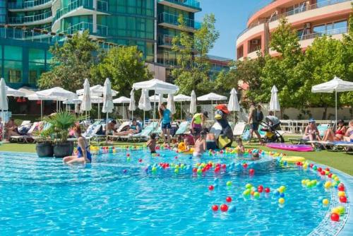 a pool full of people in a swimming pool at Двустаен апартамент в Приморско in Primorsko