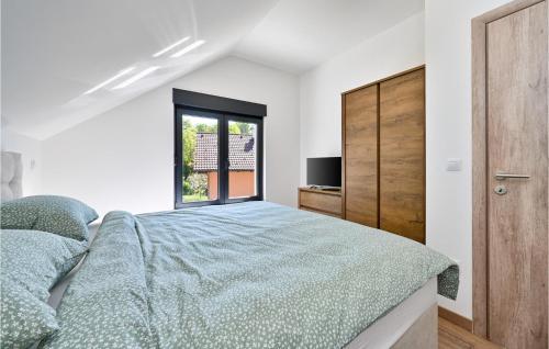 a bedroom with a bed and a window at Beautiful Home In Stubicke Toplice in Stubicke Toplice
