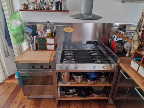 a kitchen with a stove and a counter top at Relax al Mare in Viareggio