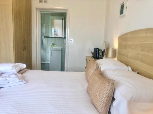 a bedroom with two beds with white sheets at The Old Quay House in Hayle