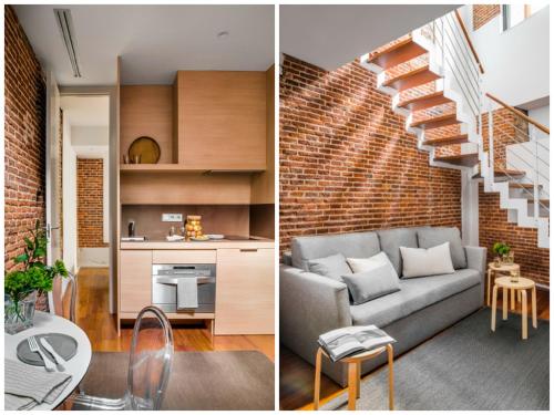 a living room and kitchen with a brick wall at Eric Vökel Boutique Apartments - Madrid Suites in Madrid