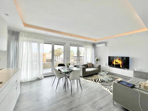 a living room with a table and a fireplace at Durres Currila RELAX Beach Lifestyle in Durrës