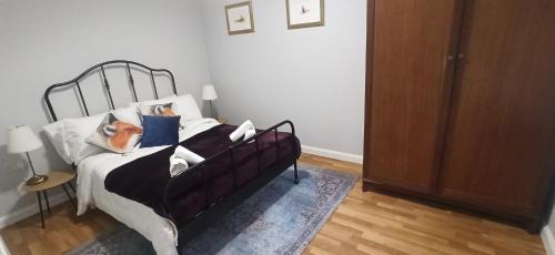 a bedroom with a bed with pillows on it at Atlantic Way Cottage in Galway