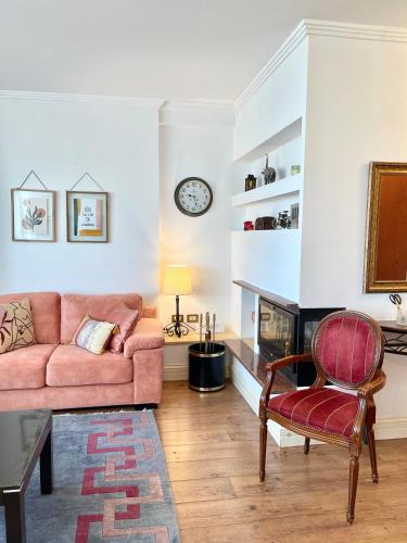 a living room with a couch and a fireplace at Metro Suites in Tirana