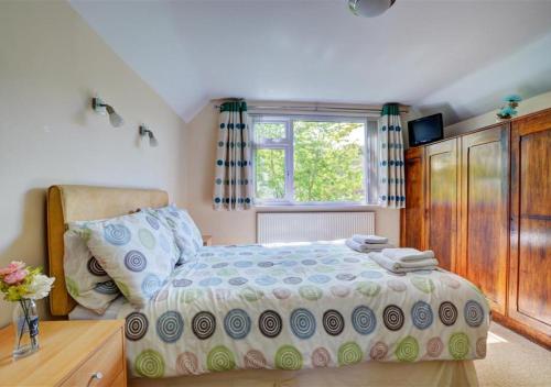 a bedroom with a bed and a window at Cleeve in Barnstaple