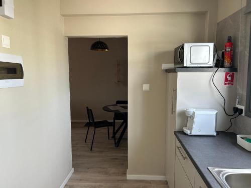 a kitchen with a microwave on top of a counter at Semeli The 3As Armonia, Ariadne, Artemis in Paphos City