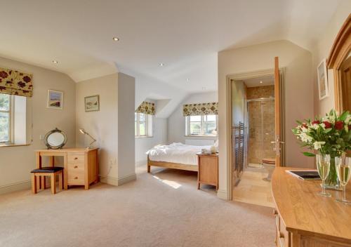 a bedroom with a bed and a dresser and a sink at Northcote Lodge in Burrington