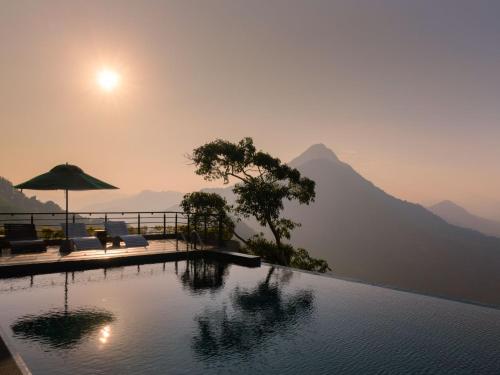 a swimming pool with a view of a mountain at Green Acres Leisure Resort & Spa in Kandy