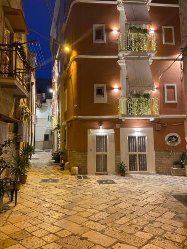 a building with two balconies and a courtyard at night at Porta Piccola Luxury Home in Bari