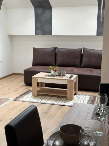 a living room with a couch and a coffee table at San Lux Dunavska in Novi Sad
