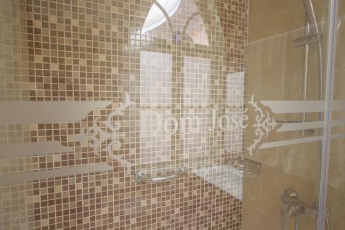 a bathroom with a shower with a glass door at Dom José Alojamentos by Guestify in Guimarães