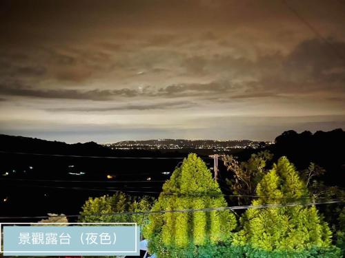 a view of a city with trees in the foreground at 沐星園villa in Tung-k'eng-ts'un