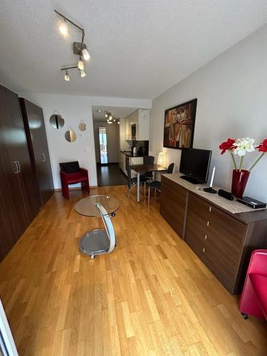a large living room with a table and a living room at Apartments Residenz Iris in Leukerbad