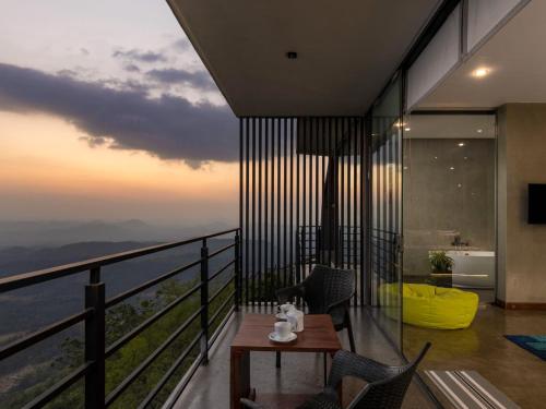 a room with a balcony with a view of the ocean at Green Acres Leisure Resort & Spa in Kandy