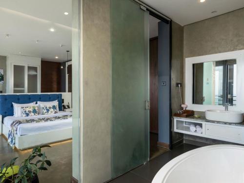 a bathroom with a bed and a sink and a tub at Green Acres Leisure Resort & Spa in Kandy