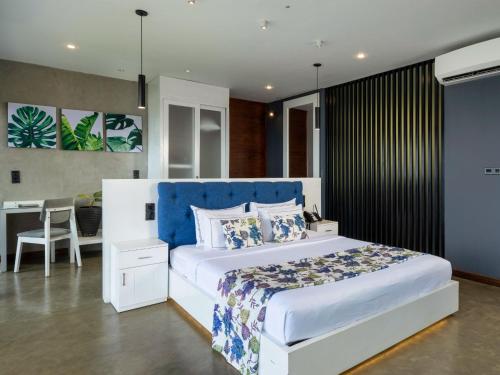 a bedroom with a large white bed and a desk at Green Acres Leisure Resort & Spa in Kandy