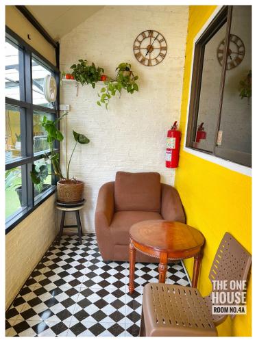 a living room with a couch and a table at The One House in Nan