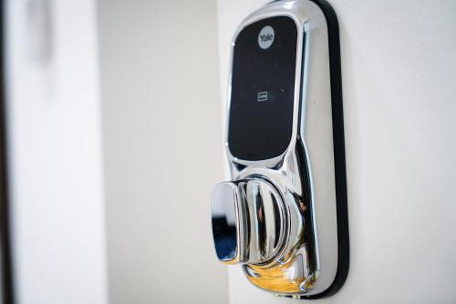 a cell phone hanging from a door handle at Centra Studios in London