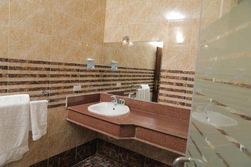 a bathroom with a sink and a mirror at Loaloat Nile Corniche El maadi in Cairo