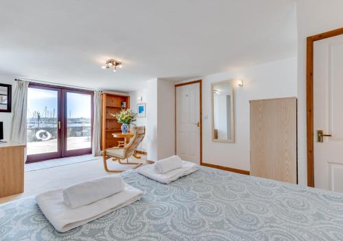 a bedroom with a large bed with two white pillows at The Anchorage in Falmouth