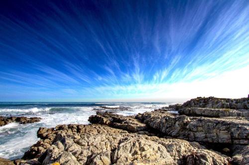 a view of the ocean from a rocky beach at Schulphoek Seafront House in Hermanus