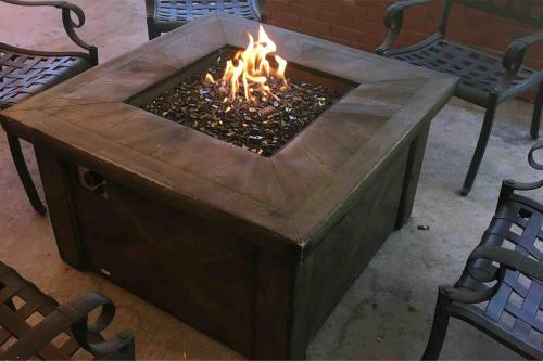 a fire pit in the middle of a patio with two benches at Beautiful Perfectly Located Hot Tub Fire Pit Bikes in Colorado Springs
