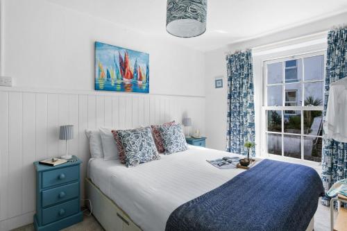 a bedroom with a bed and a window at Bay Cottage, Brixham in Brixham