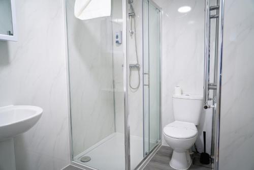 a bathroom with a shower and a toilet and a sink at Centra Studios in London